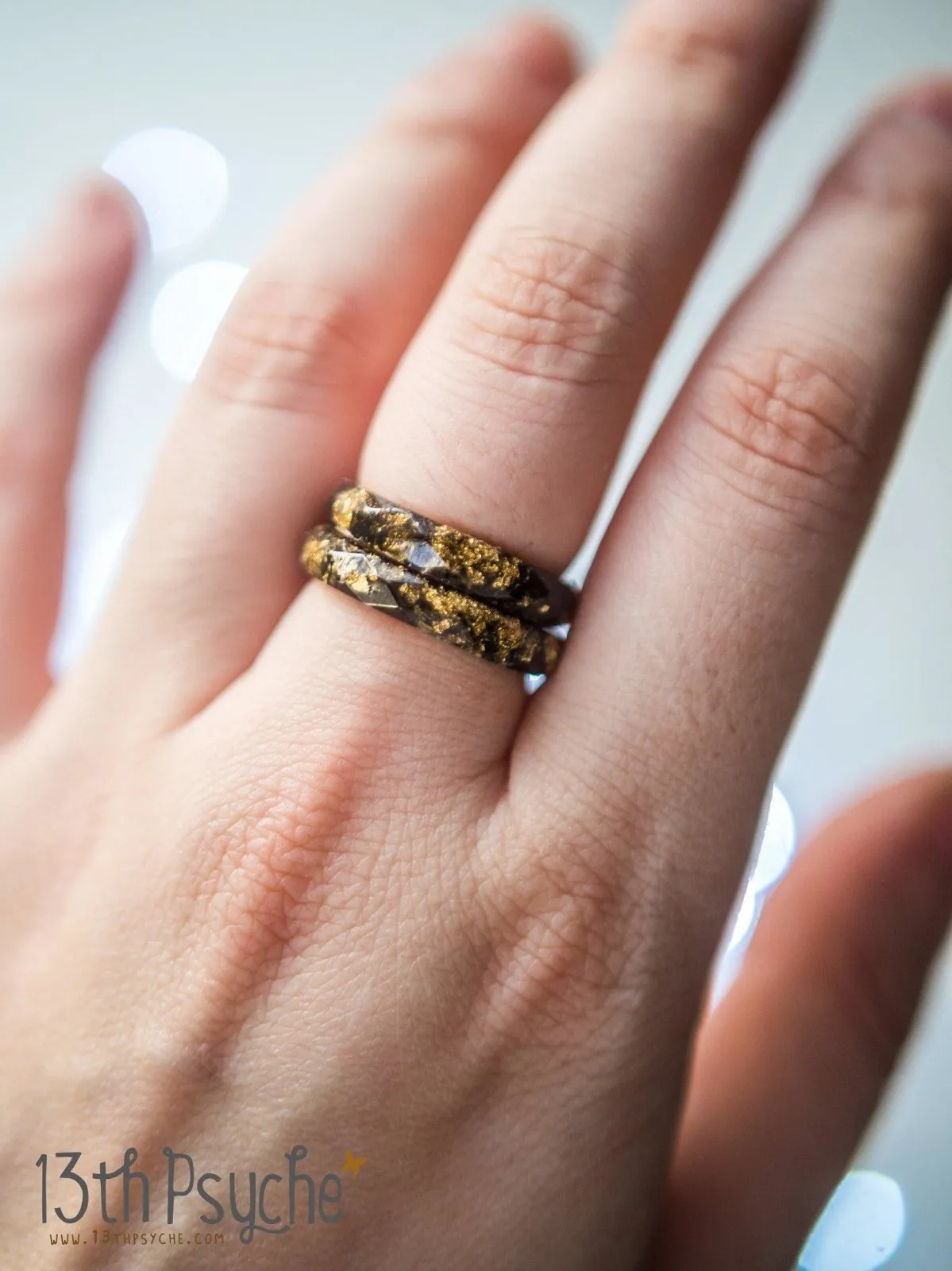 Black faceted resin ring with gold flakes